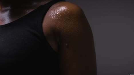 Close-Up-Shot-Of-Beads-Of-Sweat-On-Woman-Wearing-Gym-Fitness-Clothing-Exercising-2